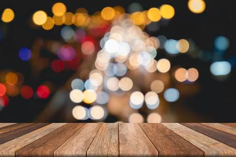 Empty wooden table on front blurred traffic bokeh background, for presentatio Stock Photos