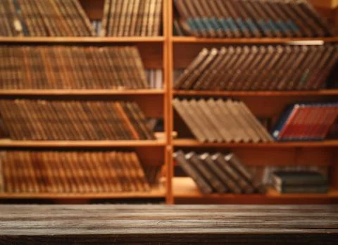 Empty wooden table in library. Space for design Stock Photos