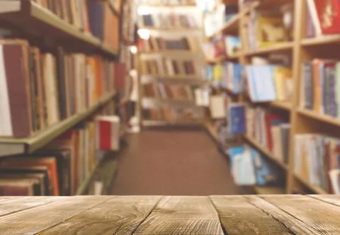 Empty wooden table in library. Space for design Stock Photos
