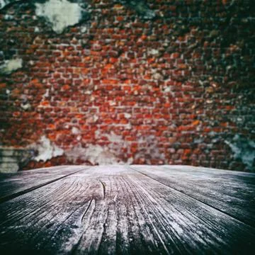 Empty wooden table with old brick wall Stock Photos