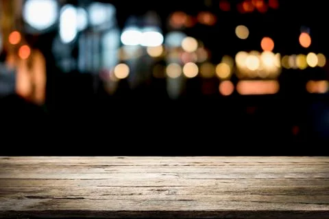 Empty wooden table platform and bokeh at night. Stock Photos