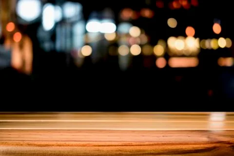 Empty wooden table platform and bokeh at night. Stock Photos