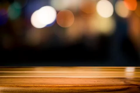Empty wooden table platform and bokeh at night. Stock Photos