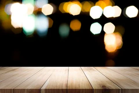 Empty wooden table platform and bokeh at night. Stock Photos