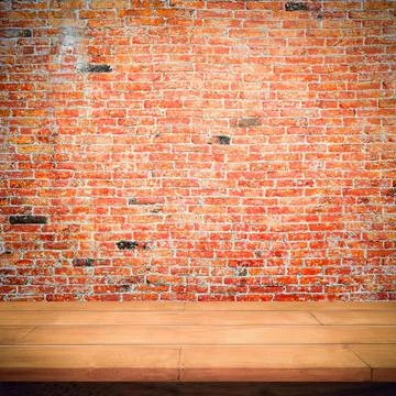 Empty wooden table with red brick wall background. Stock Photos
