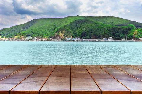 Empty wooden table space platform and Islands on the sea and sky background f Stock Photos