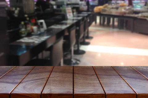 Empty wooden table space platform and blurred Supermarket aisle with product  Stock Photos