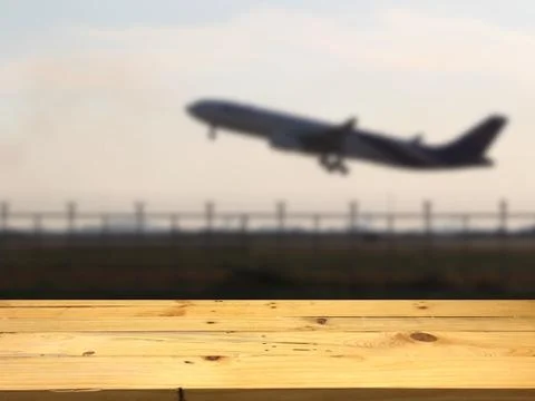Empty wooden table space platform and blurred Airplane up background for prod Stock Photos