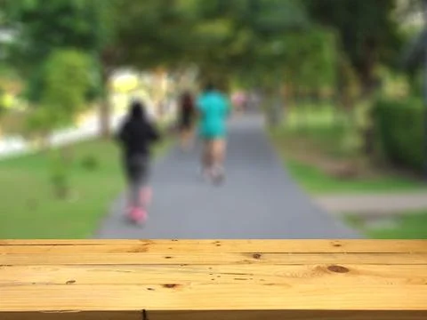 Empty wooden table space platform and blurred Jogging park background for pro Stock Photos
