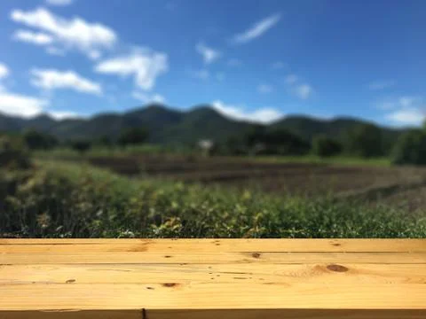 Empty wooden table space platform and blurred Wide mountains and sky backgrou Stock Photos