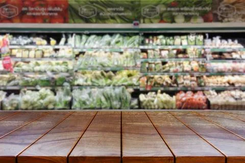 Empty wooden table space platform and blurred Supermarket aisle with product  Stock Photos