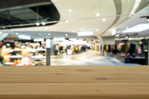 Empty wooden table space platform and blurred shopping mall Stock Photos