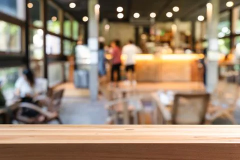 Empty wooden table space platform and blurry defocused restaurant interior, V Fotos Stock