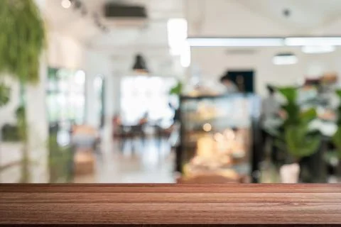 Empty wooden table space platform and blurry defocused restaurant interior Fotos Stock