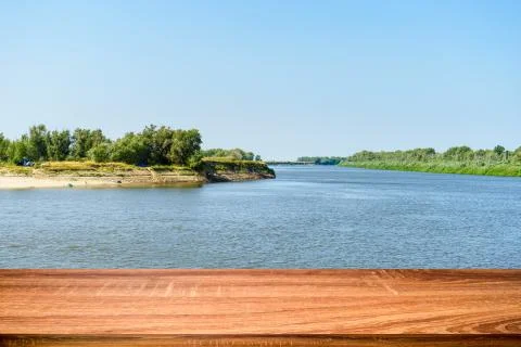 Empty wooden table with summer background of riverside in the daytime. Can be Stock Photos
