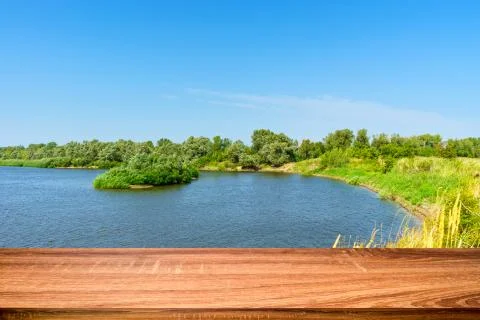 Empty wooden table with summer background of riverside in the daytime. Can be Stock Photos