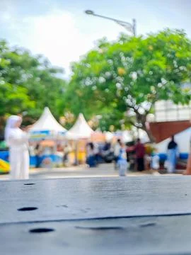 Empty wooden table surface with blurred outdoor festival background. Stock Photos