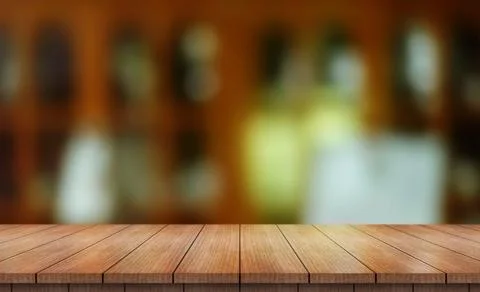 Empty wooden table top with lights bokeh on blur restaurant background (1) Photos