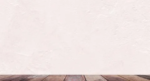Empty wooden table with a wall in the background. Stock Photos