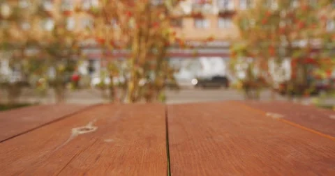 Empty wooden textured table top with defocused blurred streetscape background of Stock Footage 163202670