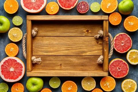 Empty wooden tray box frame, copy blank design space with citrus fruits sliced Stock Photos