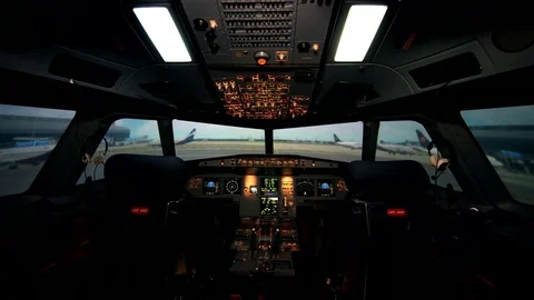 Empty workplace of aircraft pilots. Cockpit or flight deck of a modern passenger Stock Footage 77335413