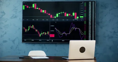Empty workplace of financial trader with open laptop and big screen Stock Footage 237992490