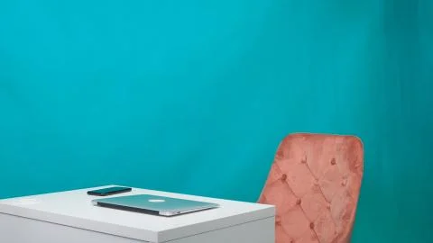 Empty workplace with laptop, white table in a modern office on a green screen. Stock Photos