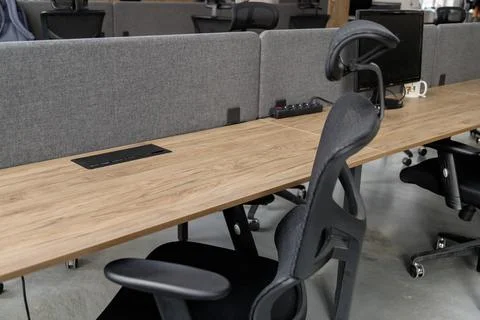 Empty workplace with table and chair at open space office interior. Stock Photos