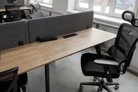 Empty workplace with table and chair at open space office interior. Stock Photos