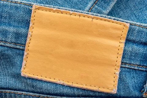 Empty worn leather patch on blue jeans. Empty space for writing. Blank leat.. Stock Photos