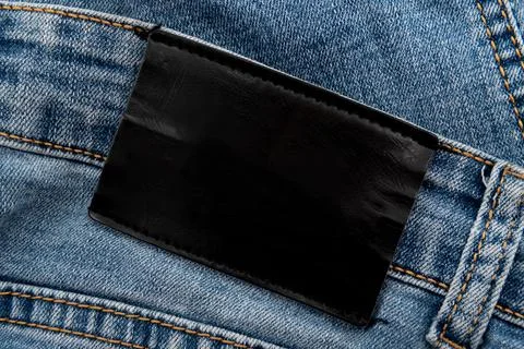 Empty worn leather patch on blue jeans. Empty space for writing. Blank leat.. Stock Photos