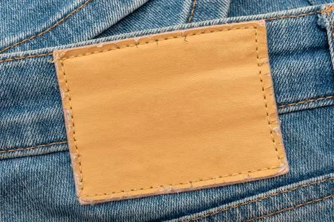 Empty worn leather patch on blue jeans. Empty space for writing. Blank leat.. Stock Photos