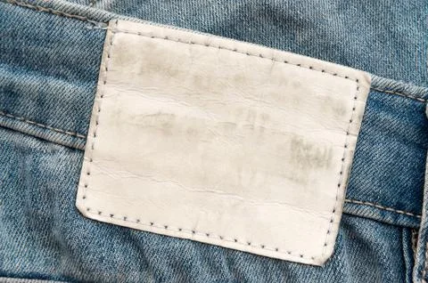 Empty worn leather patch on blue jeans. Empty space for writing. Blank leat.. Stock Photos