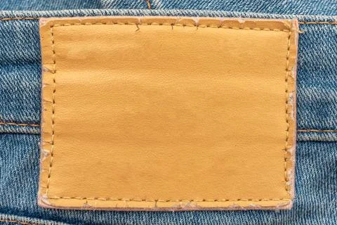 Empty worn leather patch on blue jeans. Empty space for writing. Blank leat.. Stock Photos