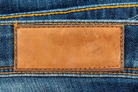 Empty worn leather patch on blue jeans. Empty space for writing. Blank leat.. Stock Photos