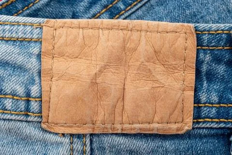 Empty worn leather patch on blue jeans. Empty space for writing. Blank leat.. Stock Photos
