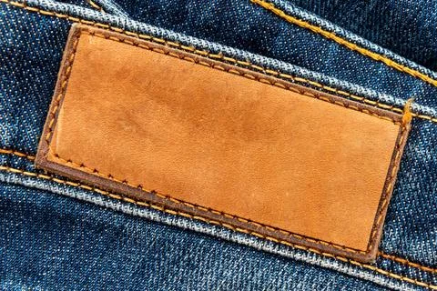 Empty worn leather patch on blue jeans. Empty space for writing. Blank leat.. Stock Photos
