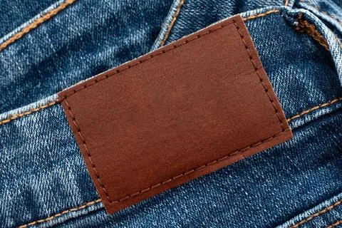 Empty worn leather patch on blue jeans. Empty space for writing. Blank leat.. Stock Photos