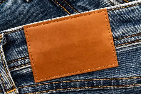 Empty worn leather patch on blue jeans. Empty space for writing. Blank leat.. Stock Photos