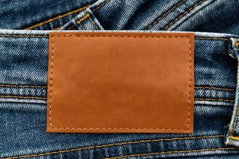 Empty worn leather patch on blue jeans. Empty space for writing. Blank leat.. Stock Photos