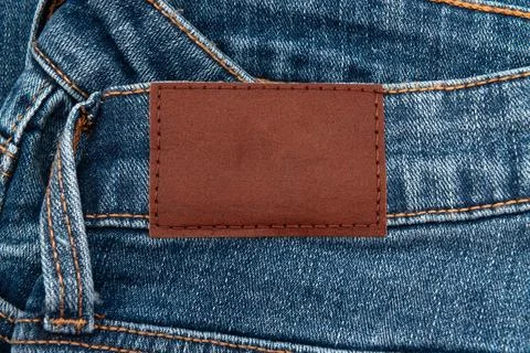 Empty worn leather patch on blue jeans. Empty space for writing. Blank leat.. Stock Photos