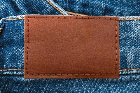 Empty worn leather patch on blue jeans. Empty space for writing. Blank leat.. Stock Photos