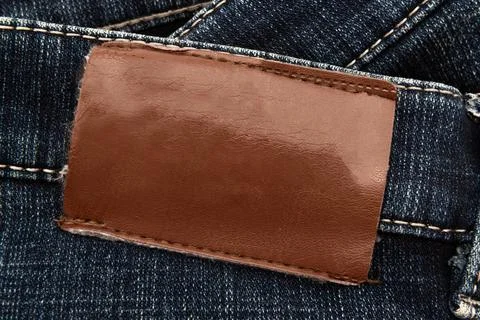 Empty worn leather patch on blue jeans. Empty space for writing. Blank leat.. Stock Photos
