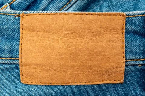 Empty worn leather patch on blue jeans. Empty space for writing. Blank leat.. Stock Photos