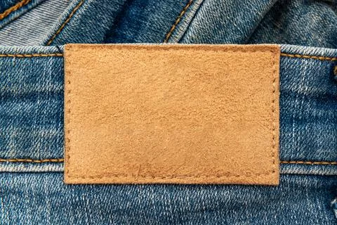 Empty worn leather patch on blue jeans. Empty space for writing. Blank leat.. Stock Photos