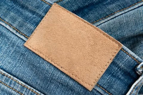 Empty worn leather patch on blue jeans. Empty space for writing. Blank leat.. Stock Photos