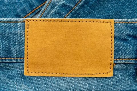 Empty worn leather patch on blue jeans. Empty space for writing. Blank leat.. Stock Photos