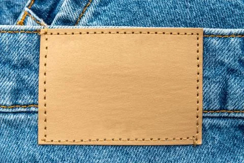 Empty worn leather patch on blue jeans. Empty space for writing. Blank leat.. Stock Photos