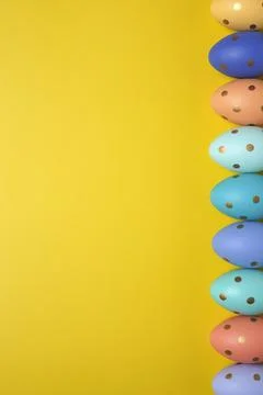 Empty yellow background with Easter eggs Stock Photos